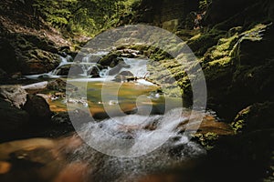 Waterfall or cascade with mountain river along hiking trail