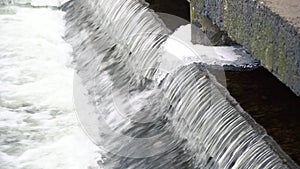 Waterfall cascade water jet, spray and splash. Close up of crystal clear water cascades over rocks. Water energy.
