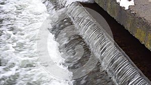 Waterfall cascade water jet, spray and splash. Close up of crystal clear water cascades over rocks. Water energy.