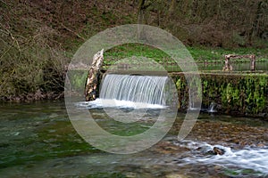 Waterfall cascades on the River Lathkill, Lathkill Dale, Peak District, Derbyshire