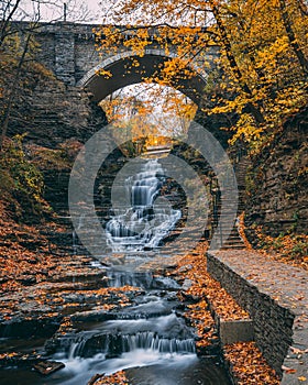 Waterfall in Cascadilla Gorge with autumn color, in Ithaca, New York