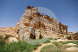 Waterfall cascading through desert canyon in Tamaqzah, Tunisia