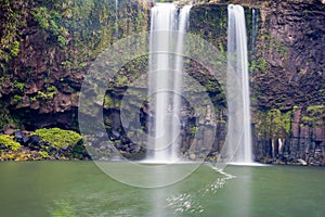 Waterfall cascading over cliff into peaceful pool