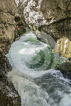 Waterfall cascading over rocks in blue pond