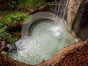 Waterfall Cascading into Rock Pool in the Jungle