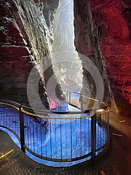 waterfall in cave with colored lights cascate del varone photo