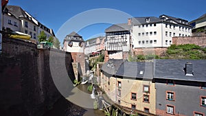 Waterfall in the city center of Saarburg, Germany surrounded by houses on a hill