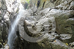 Waterfall close up. Water cascade on moss stones