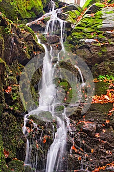 Waterfall in creek in Turovska roklina gorge during autumn in Kremnicke vrchy mountains