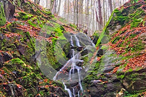 Waterfall in creek in Turovska roklina gorge during autumn in Kremnicke vrchy mountains