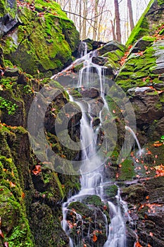 Waterfall in creek in Turovska roklina gorge during autumn in Kremnicke vrchy mountains