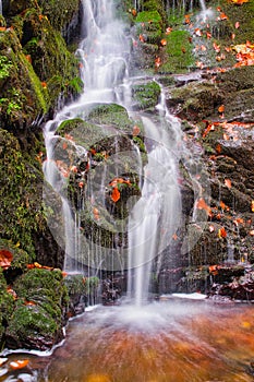 Waterfall in creek in Turovska roklina gorge during autumn in Kremnicke vrchy mountains