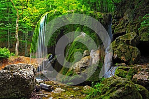 Waterfall in Crimea forest and wet mossy stone photo