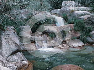 Waterfall of crystal clear water in a mountain river. Winter scene