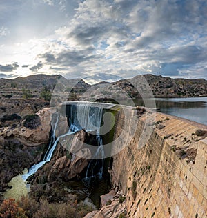 The waterfall and dam of the Elche Reservoir and lake in Alicante Province of Spain