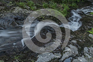 Waterfall on Divoky creek near Kouty nad Desnou village in summer day