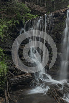 Waterfall on Divoky creek near Kouty nad Desnou village in summer day