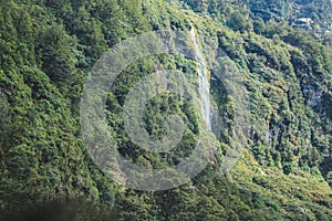 Waterfall at Doubtful Sound - passing beautiful scenery in Fiordland National Park, South Island, New Zealand