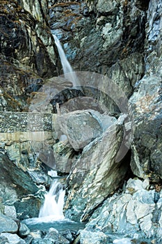Waterfall Drops Under Rock Wall Bridge