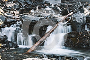 Waterfall with fallen tree across