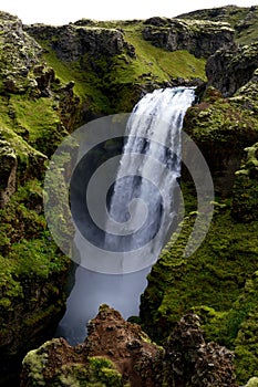 Waterfall falling into a canyon at waterfall trail from SkÃ³gar to PorsmÃ¶rk, Iceland