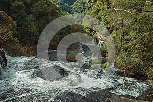 Waterfall falling over rocks in a lush forest