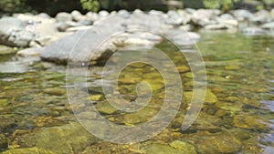 Waterfall are flowing through a rock during the shallow water