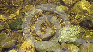 Waterfall are flowing through a rock during the shallow water