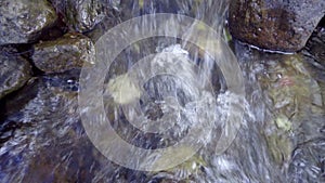 Waterfall are flowing through a rock during the shallow water