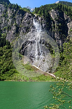 Waterfall flows over granite roocks in the mountains, Stillup Lake, Austria, Tyrol