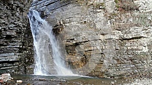 Waterfall flows through the rock