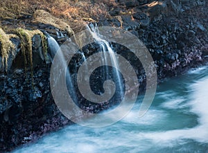 Waterfall flows into sea at Queens Bath Kauai