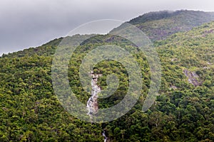 The waterfall flows from the top of the mountain