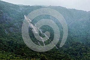 The waterfall flows from the top of the mountain