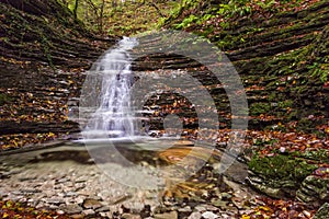 Waterfall in the forest in autumn, Monte Cucco NP, Umbria, Italy