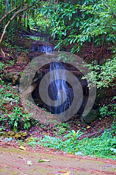 Waterfall in the forest flown through rock rushing over the stones