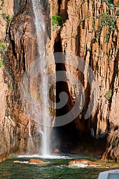 Waterfall in front of red rocks