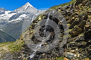 Waterfall in front of the Weisshorn peak, Switzerland