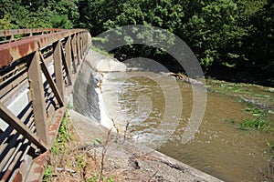 This waterfall is gently tucked under this bridge