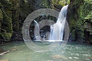 Waterfall in green mossy rock