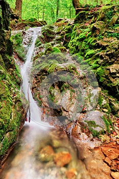 Waterfall with green stones