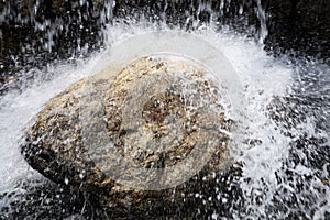 Waterfall hitting a rock