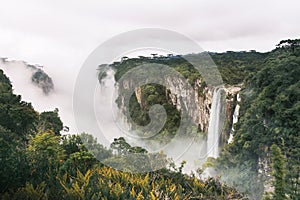 Waterfall of Itaimbezinho Canyon with fog at Aparados da Serra National Park - Cambara do Sul, Rio Grande do Sul, Brazil photo