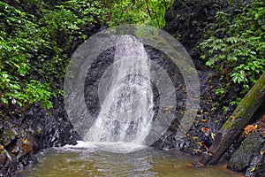 Waterfall Jaco Costa Rica, Catarastas Valle Encantado - Hidden waterfall surrounded by green trees, vegetation, rocks, leaves floa photo