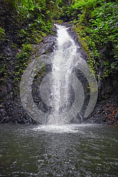 Waterfall Jaco Costa Rica, Catarastas Valle Encantado - Hidden waterfall surrounded by green trees, vegetation, rocks, leaves floa photo