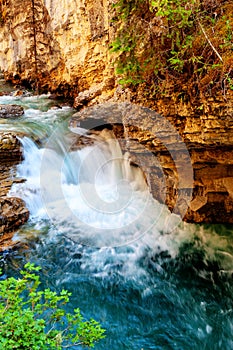 Waterfall at Johnston Canyon Flowing Down Creek