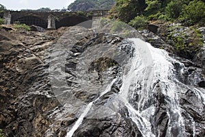 Waterfall in the jungle, a beautiful view of the railway on cliff .Indiya Goa