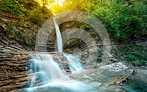 Waterfall `Lace` in the mountains illuminated by the sun. Gelendzhik, North Caucasus, Russia