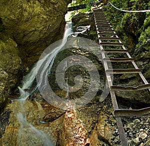 Waterfall with ladder in canyon