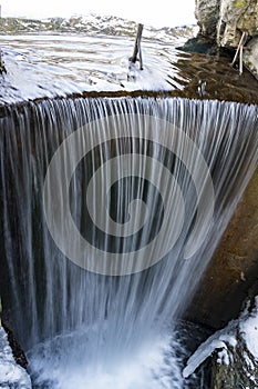 The waterfall of Lake Smeraldo in Fondo in winter